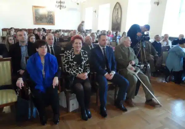 Uczestnicy wydarzenia związani z wręczeniem nagrody „O Szablę Komendanta” w sali udekorowanej tradycyjnymi elementami.