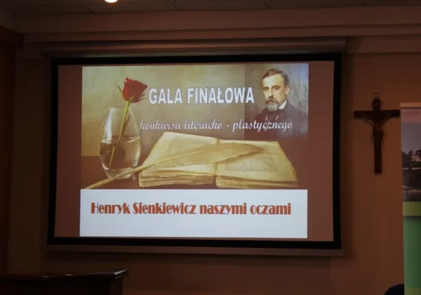 Slajd projekcyjny z napisem „Gala finałowa konkursu literacko-plastycznego” przedstawiający otwartą książkę, kieliszek z wodą i różę oraz portret mężczyzny w tle.