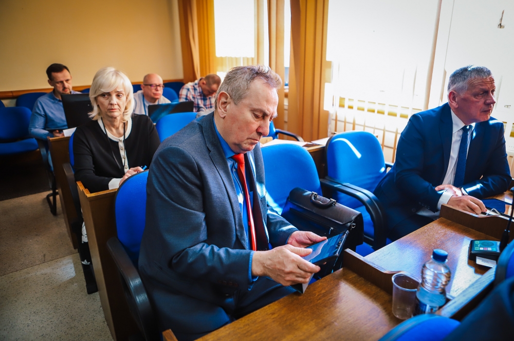 Radny powiatu sprawdza coś na tablecie