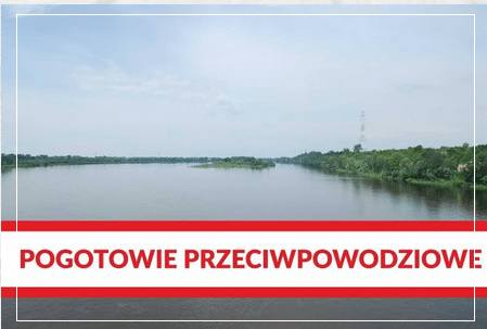 Widok na rzekę z napisem "Pogotowie przeciwpowodziowe" w dolnej części zdjęcia.